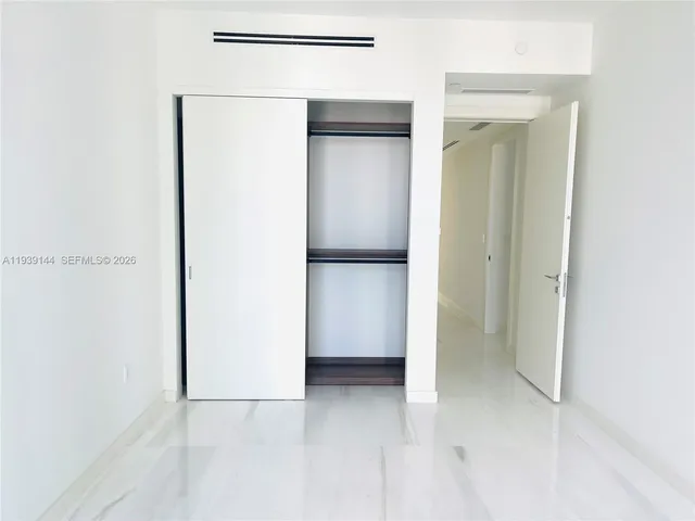 a view of an empty room with glass door