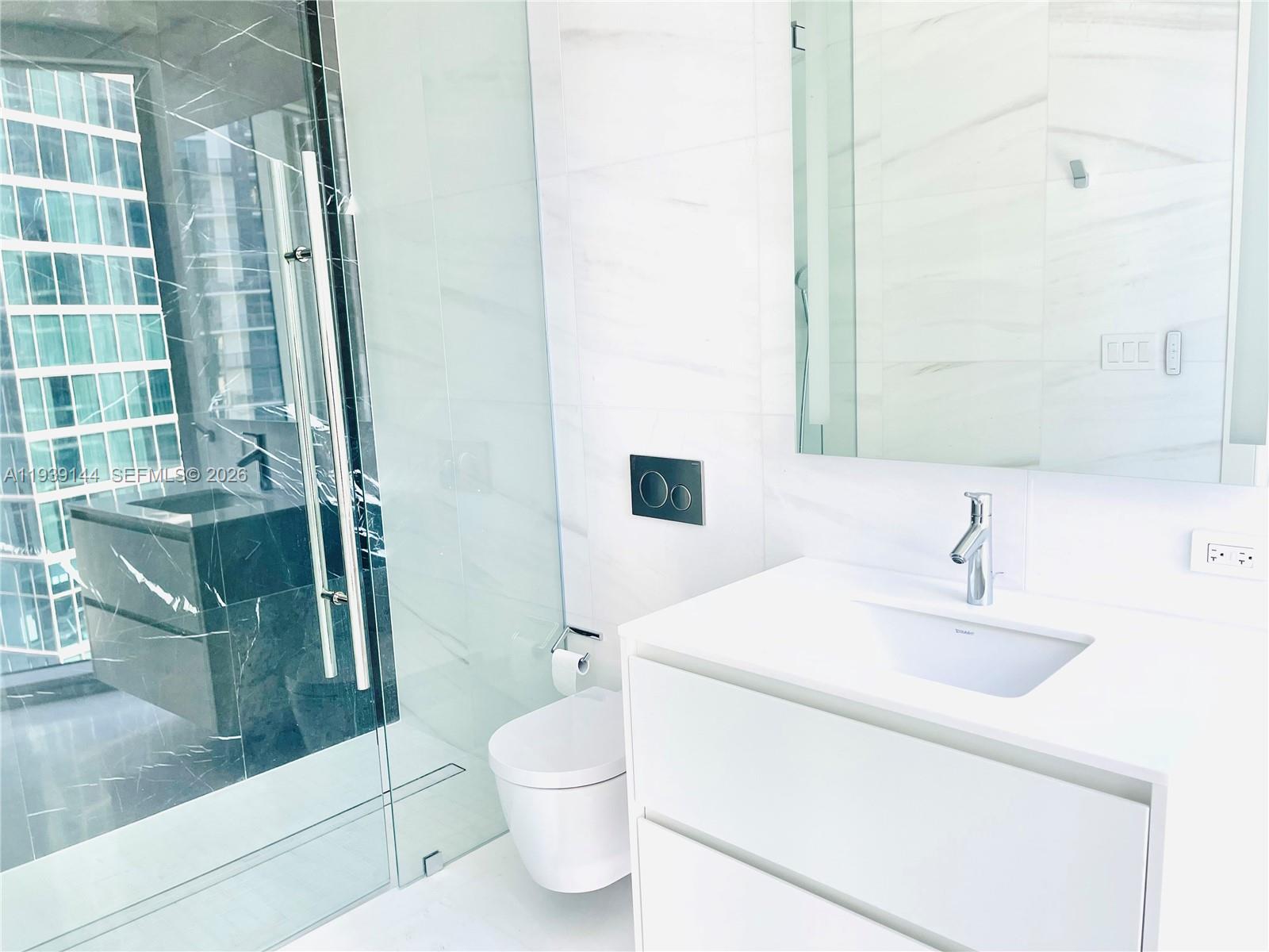 300 Biscayne Blvd Way, Unit 2807 Miami, FL 33131 - Photo 46 of 59 a bathroom with a sink a toilet and shower