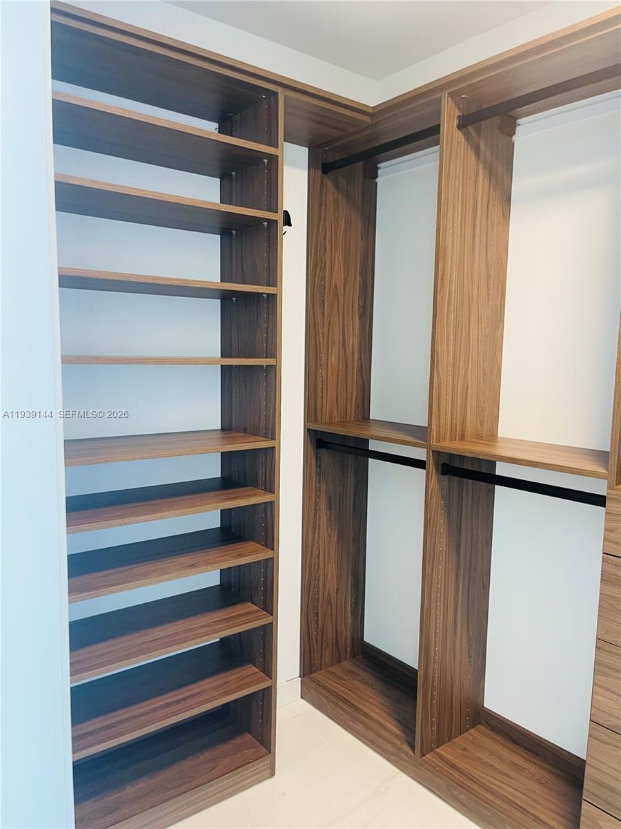 300 Biscayne Blvd Way, Unit 2807 Miami, FL 33131 - Photo 52 of 59 a view of walk in closet with empty racks