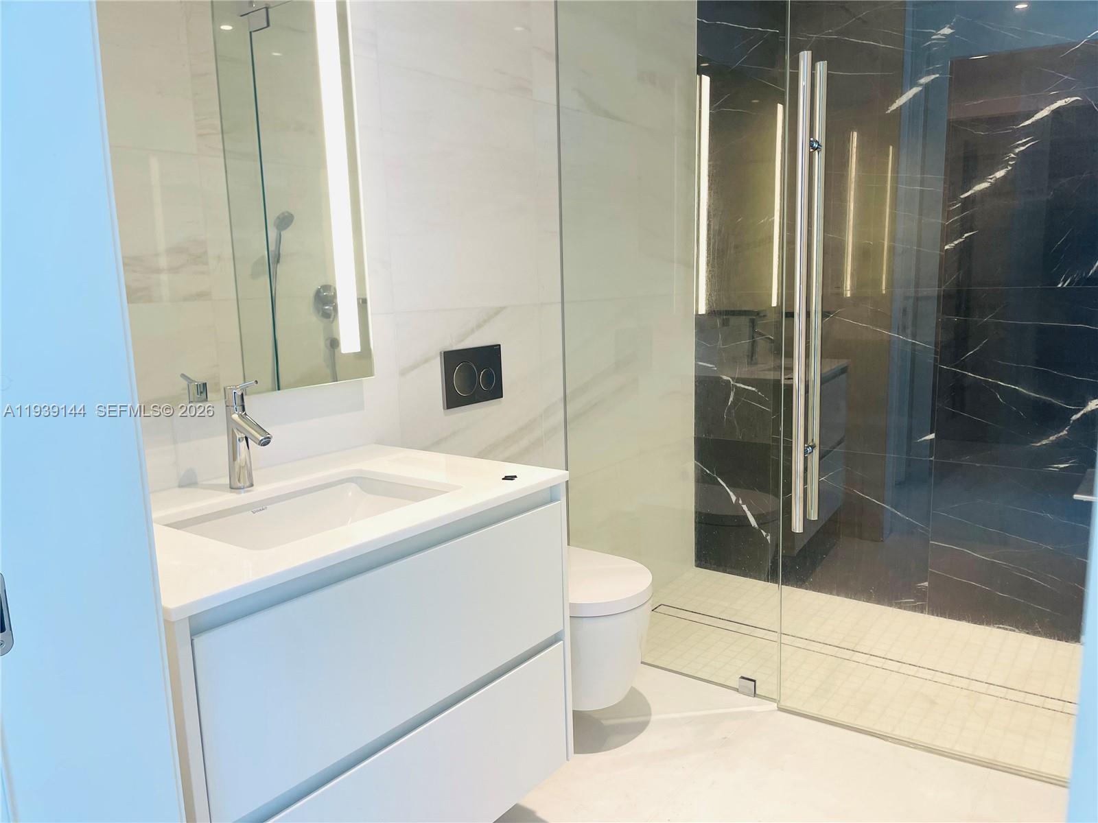 300 Biscayne Blvd Way, Unit 2807 Miami, FL 33131 - Photo 55 of 59 a bathroom with a sink toilet and shower