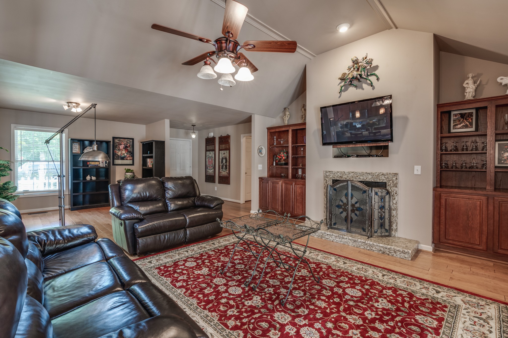 7139 New Hope Road Fairview, TN 37062 - Photo 11 of 41 a living room with furniture a fireplace and a flat screen tv