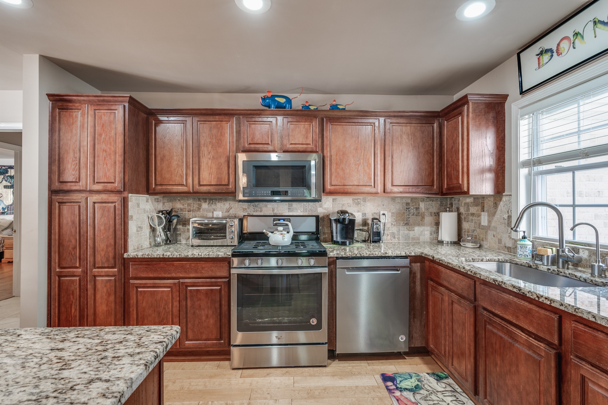 7139 New Hope Road Fairview, TN 37062 - Photo 14 of 41 a kitchen with stainless steel appliances granite countertop a stove a sink dishwasher and a microwave