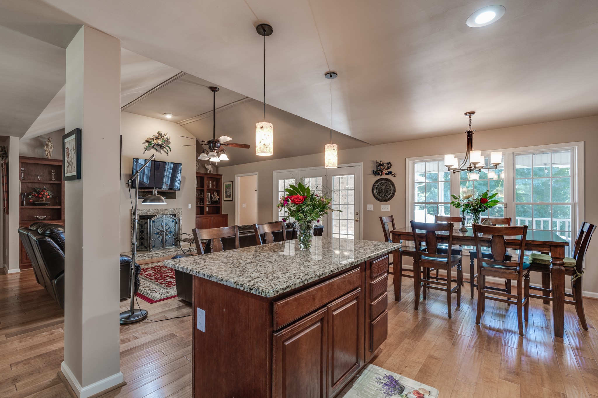 7139 New Hope Road Fairview, TN 37062 - Photo 15 of 41 a view of a dining room and livingroom with furniture wooden floor a chandelier