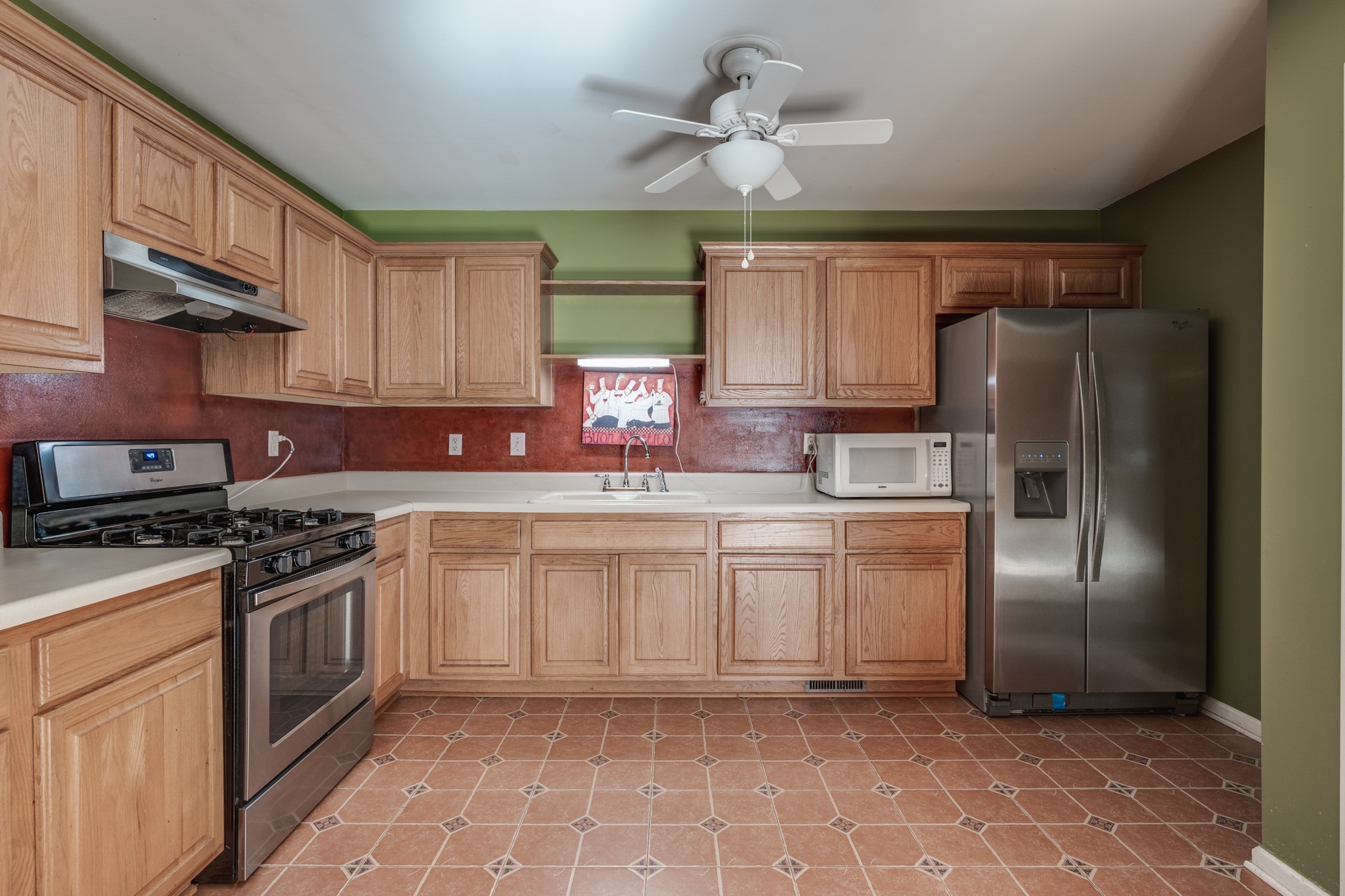 7139 New Hope Road Fairview, TN 37062 - Photo 29 of 41 a kitchen with stainless steel appliances granite countertop a refrigerator a stove a sink and a microwave