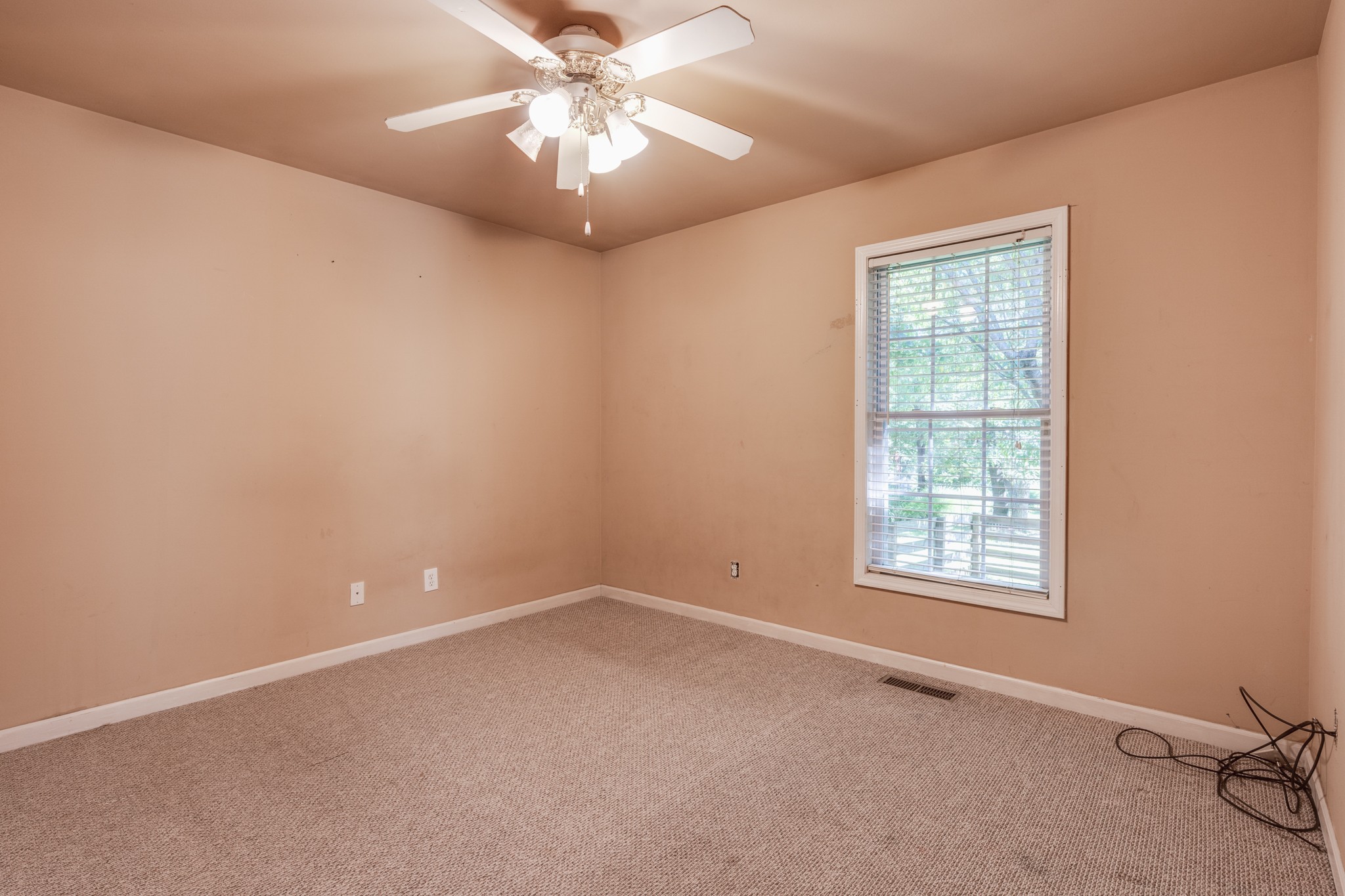 7139 New Hope Road Fairview, TN 37062 - Photo 33 of 41 an empty room with a chandelier fan and windows