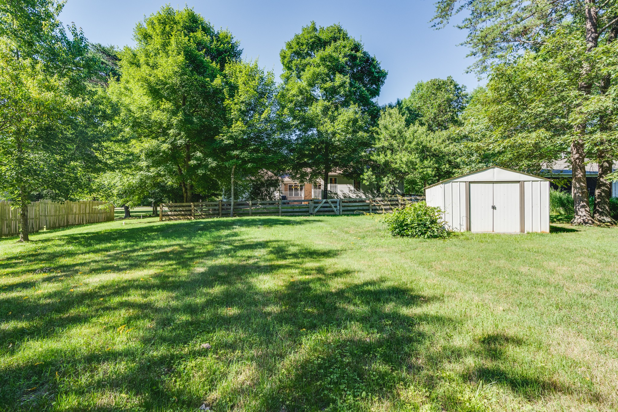 7139 New Hope Road Fairview, TN 37062 - Photo 39 of 41 a backyard of a house with plants and large trees