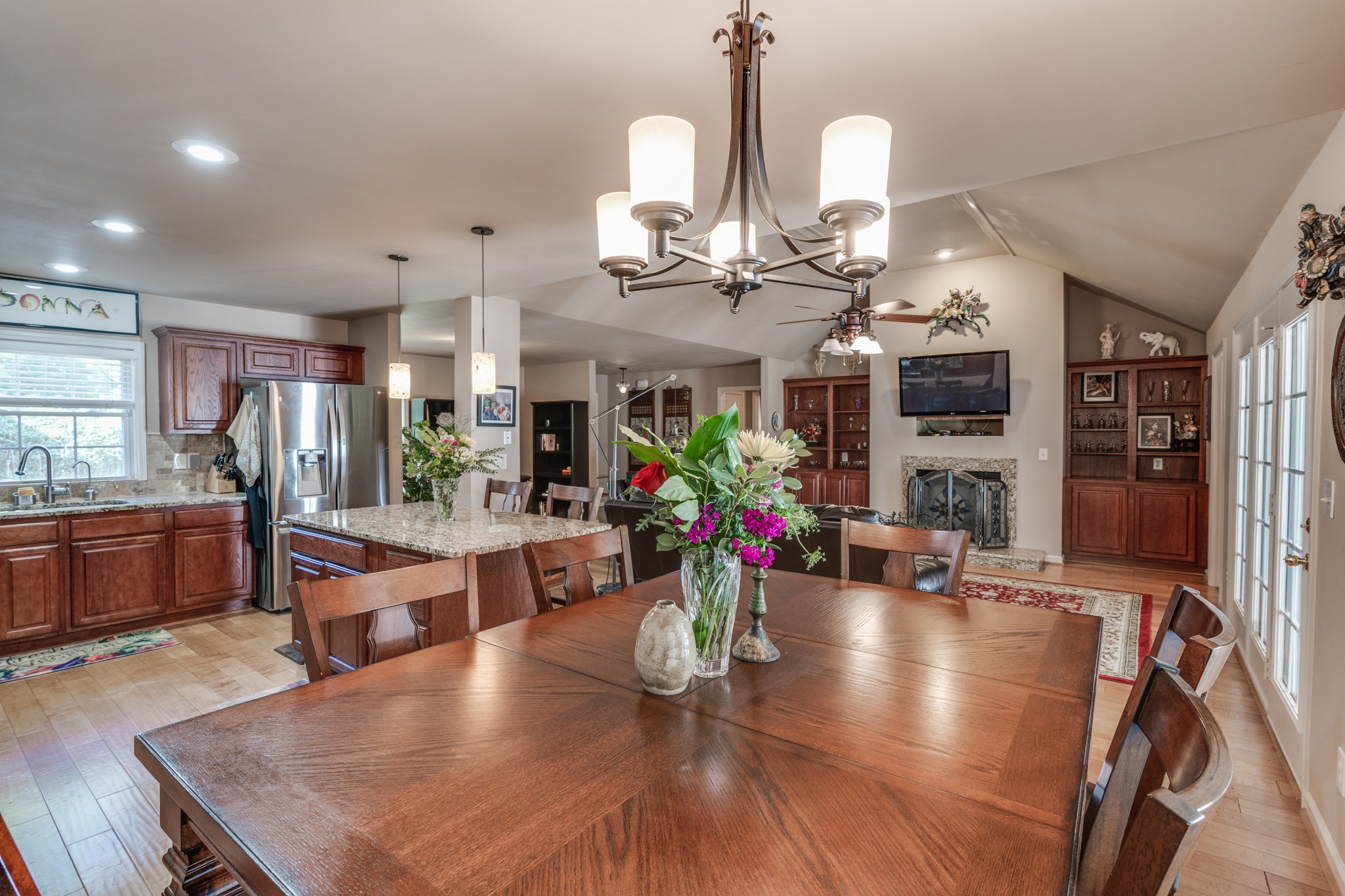 7139 New Hope Road Fairview, TN 37062 - Photo 10 of 41 a view of a dining room and livingroom with furniture wooden floor a chandelier