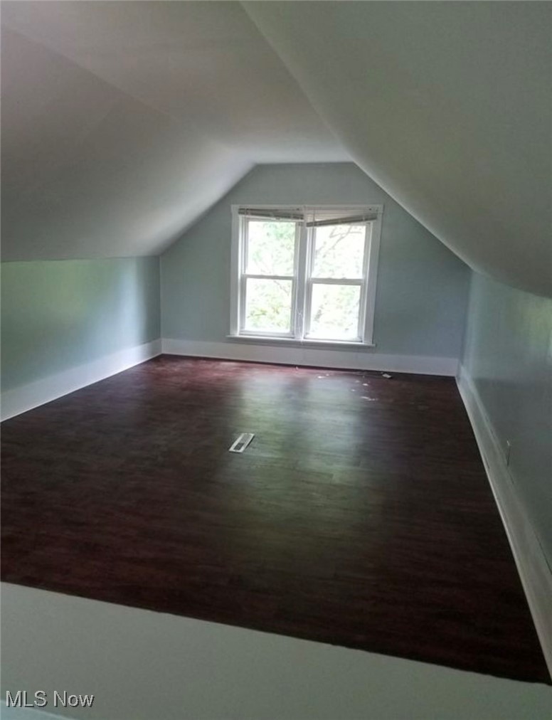 835 Berwin Street Akron, OH 44310 - Photo 16 of 18 Bonus room with lofted ceiling, visible vents, baseboards, and wood finished floors