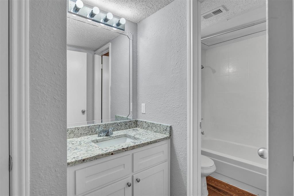 11311 Audelia Road, Unit 221 Dallas, TX 75243 - Photo 11 of 22 a bathroom with a granite countertop sink and a mirror
