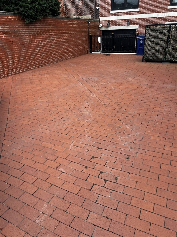 a view of swimming pool and brick wall