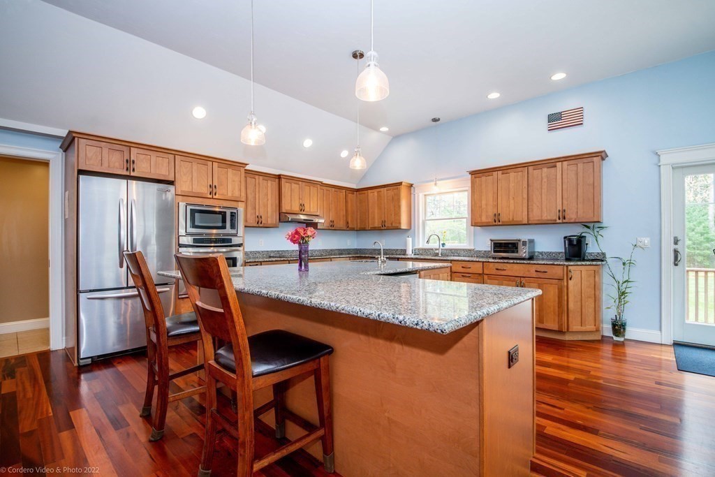 558 County Road Wareham, MA 02576 - Photo 5 of 32 a kitchen with stainless steel appliances granite countertop a refrigerator a stove top oven a sink dishwasher and white cabinets with wooden floor