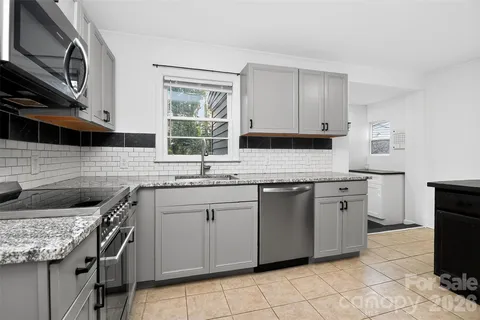 a kitchen with a refrigerator and a stove