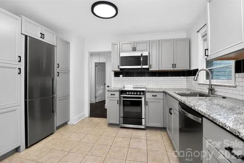 a kitchen with a sink and a toilet