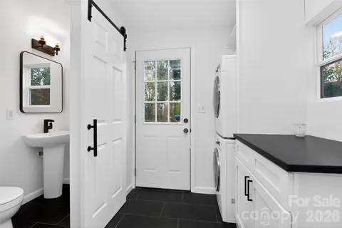 a bathroom with a sink a mirror and window