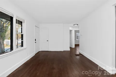 a view of a kitchen with wooden floor and a sink