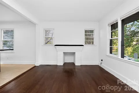 a kitchen with a sink window and cabinets