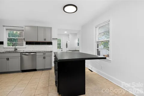 a kitchen with stainless steel appliances a stove sink microwave and cabinets