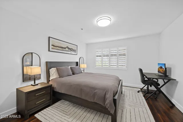 a bedroom with a bed and a desk