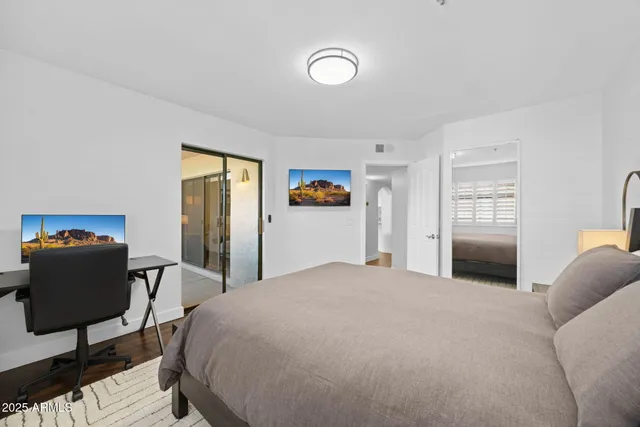 a bedroom with a bed and chair