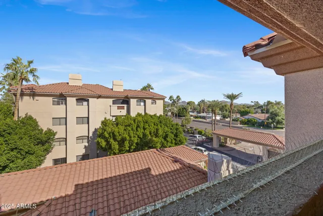 a view of a street with a bench in front of it