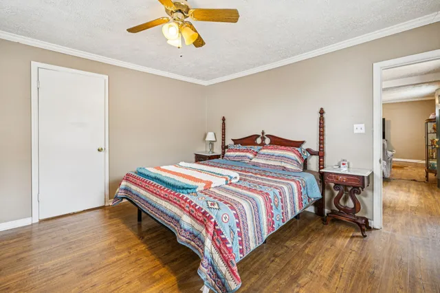 a bedroom with a bed and wooden floor