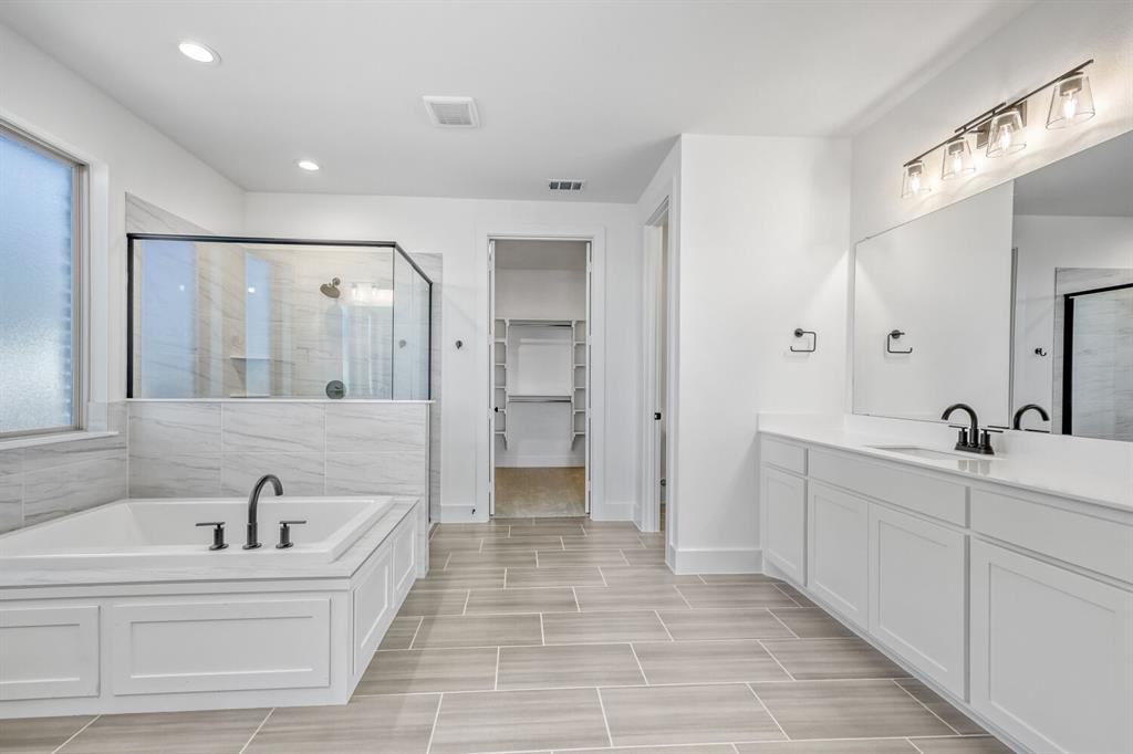 147 Derrett Lane Rhome, TX 76078 - Photo 15 of 28 Full bath featuring a shower stall, a garden tub, vanity, a walk in closet, and recessed lighting