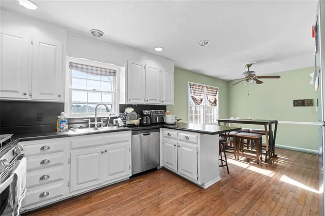 a kitchen with sink cabinets and wooden floor