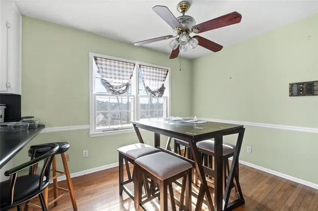 a view of a dining room with furniture window and wooden floor
