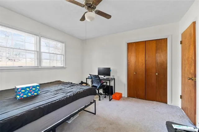 a bedroom with bed and window