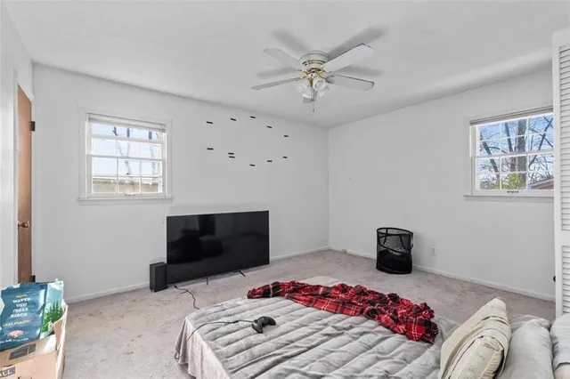 a bedroom with a bed and a television