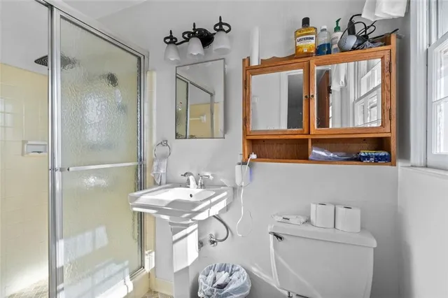 a bathroom with a sink toilet and shower
