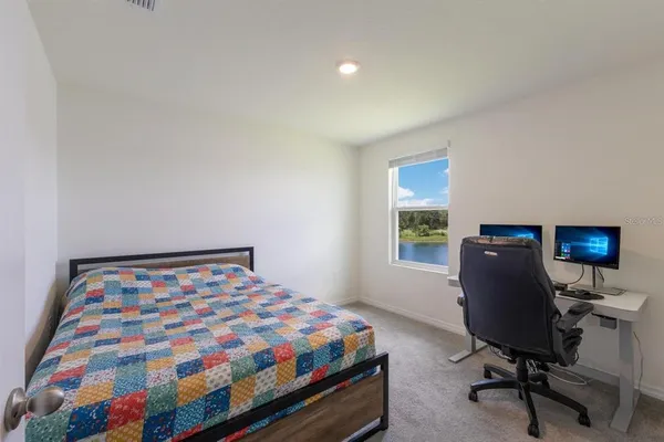 a bedroom with a bed and a desk