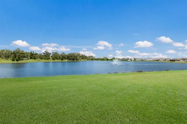 a view of a lake with houses in the back