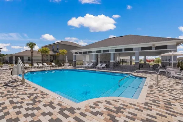 a view of a patio with swimming pool table and chairs