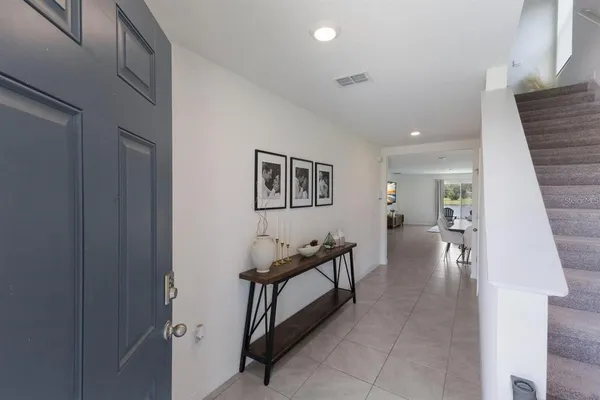 a hallway with furniture and stairs