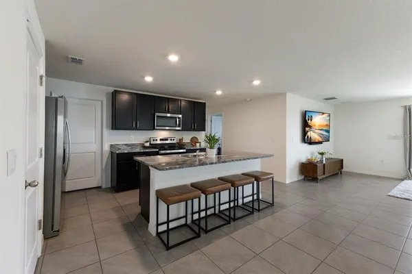 a kitchen with stainless steel appliances a refrigerator and a stove top oven