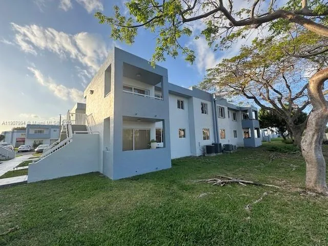 a large tree in front of a house