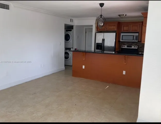 a living room with a furniture and a chandelier