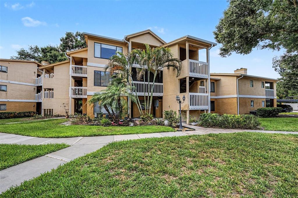 1550 South Belcher Road, Unit 525 Clearwater, FL 33764 - Photo 1 of 28 a front view of a house with a yard and trees