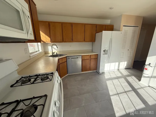 a kitchen with a stove a refrigerator and a sink