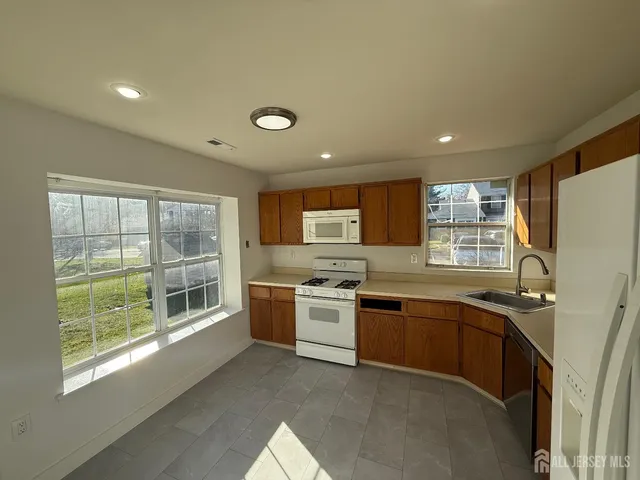 a kitchen with stainless steel appliances granite countertop a stove and a sink