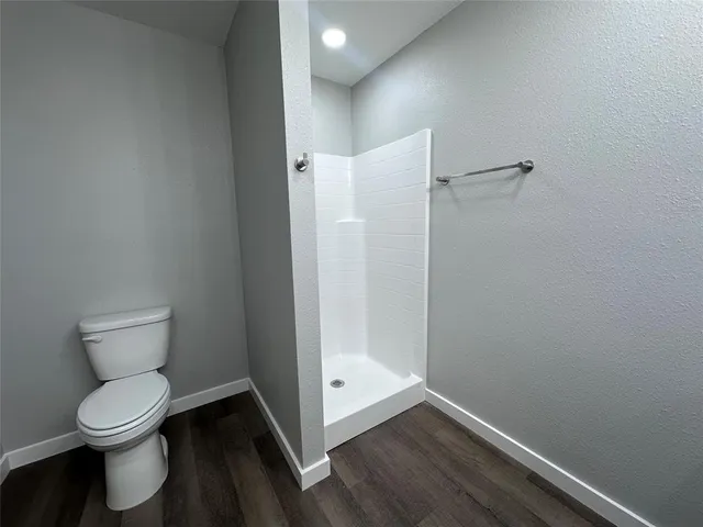 a white toilet sitting next to a bathroom sink