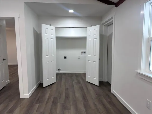 a view of hallway with wooden floor