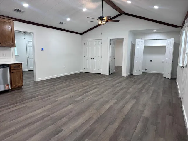 a view of empty room with wooden floor