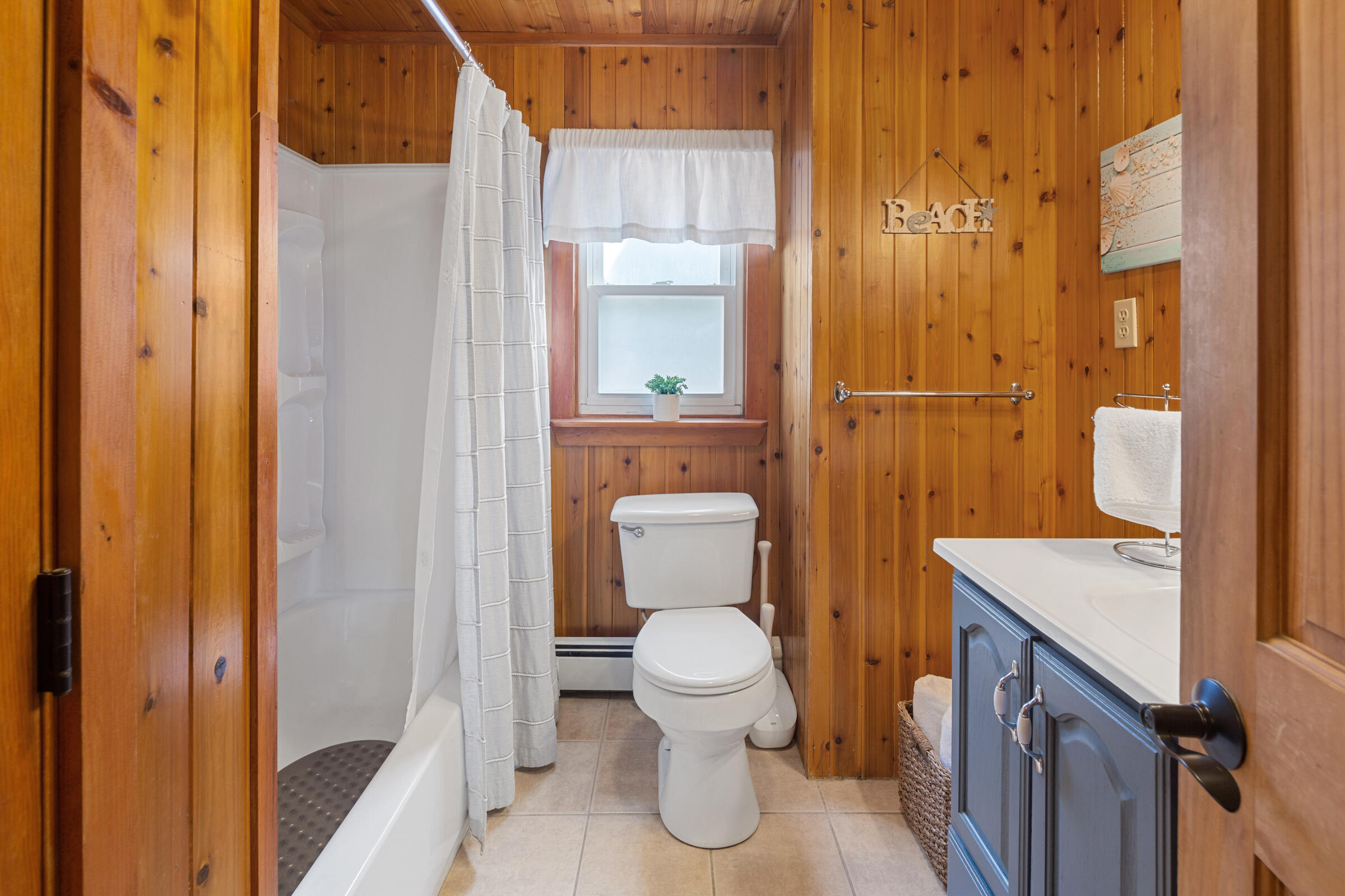 31 Soundview Road Centerville, MA 02632 - Photo 17 of 50 a bathroom with a toilet a sink and glass door