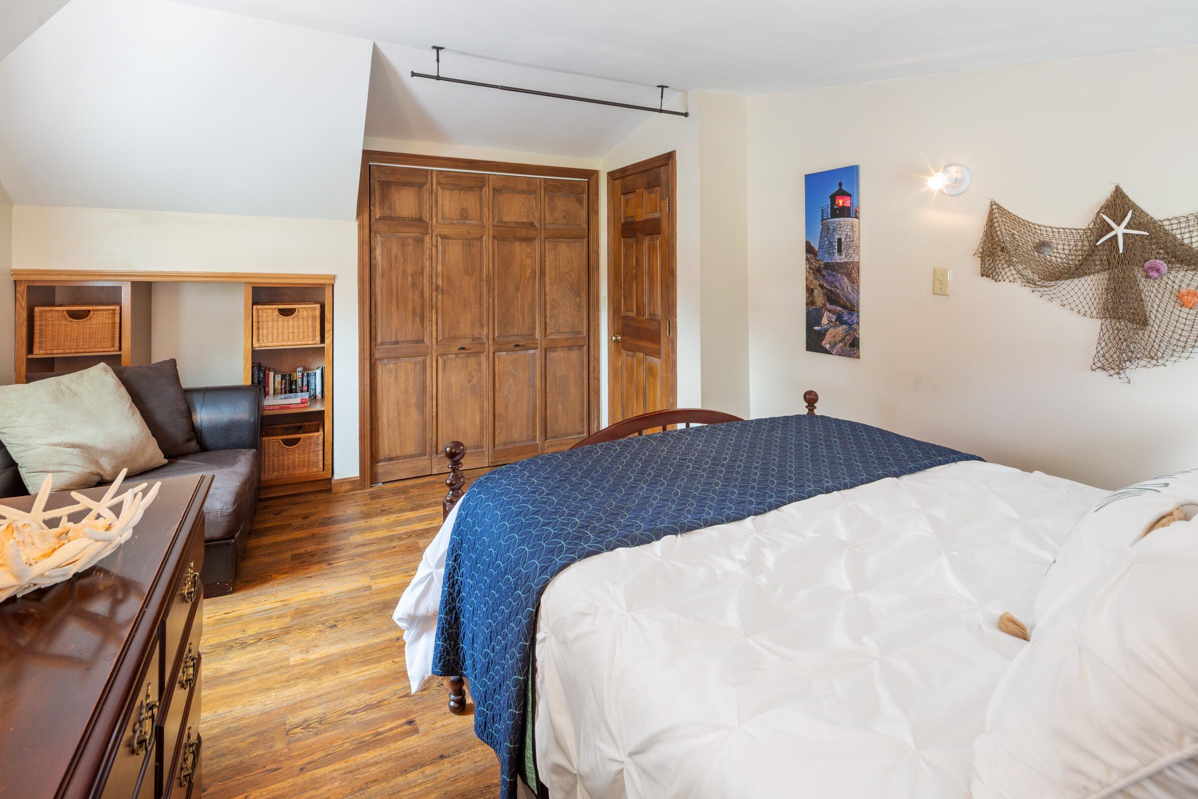 31 Soundview Road Centerville, MA 02632 - Photo 27 of 50 a spacious bedroom with a bed and wooden floor