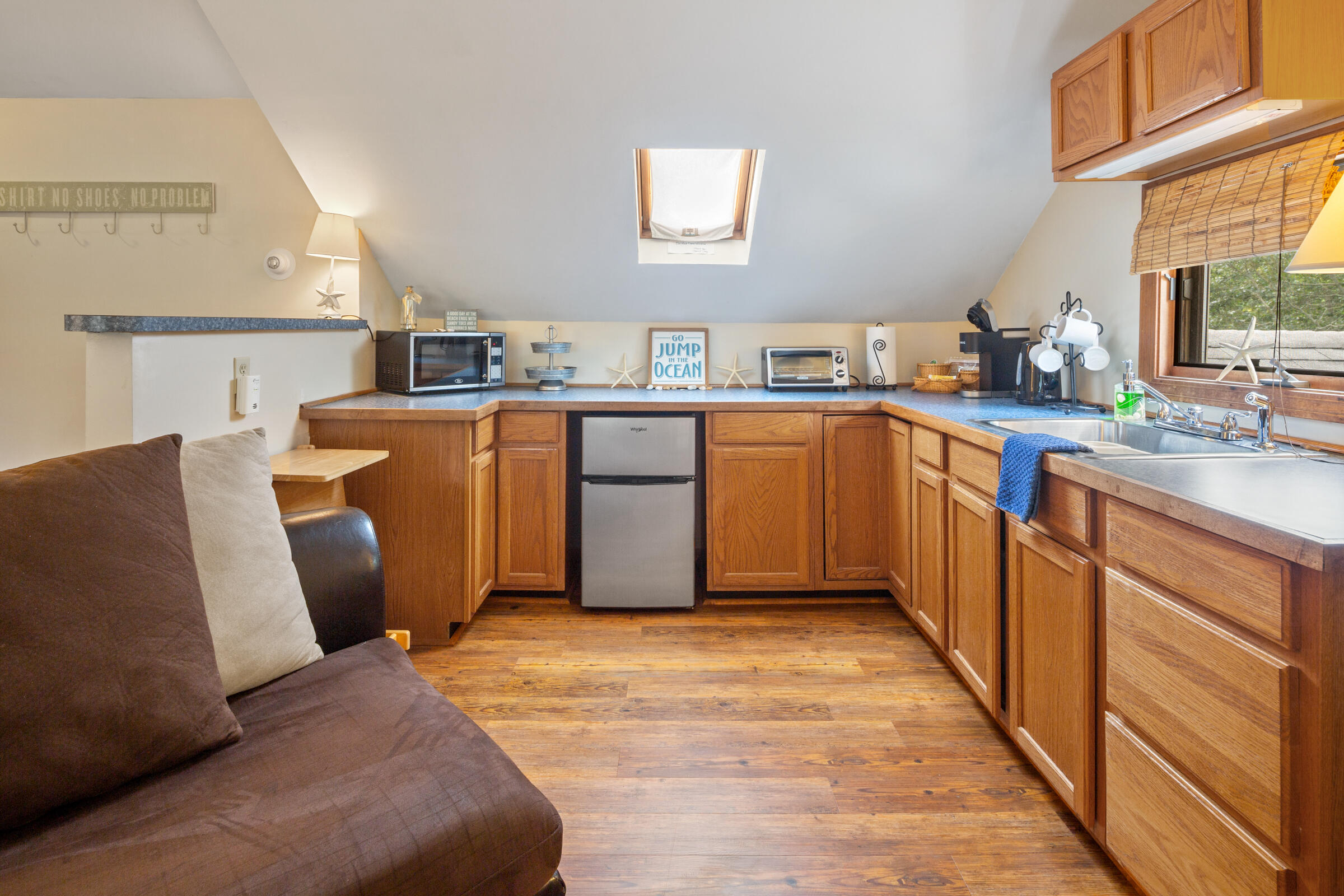 31 Soundview Road Centerville, MA 02632 - Photo 29 of 50 a kitchen with stainless steel appliances granite countertop a refrigerator sink and wooden cabinets