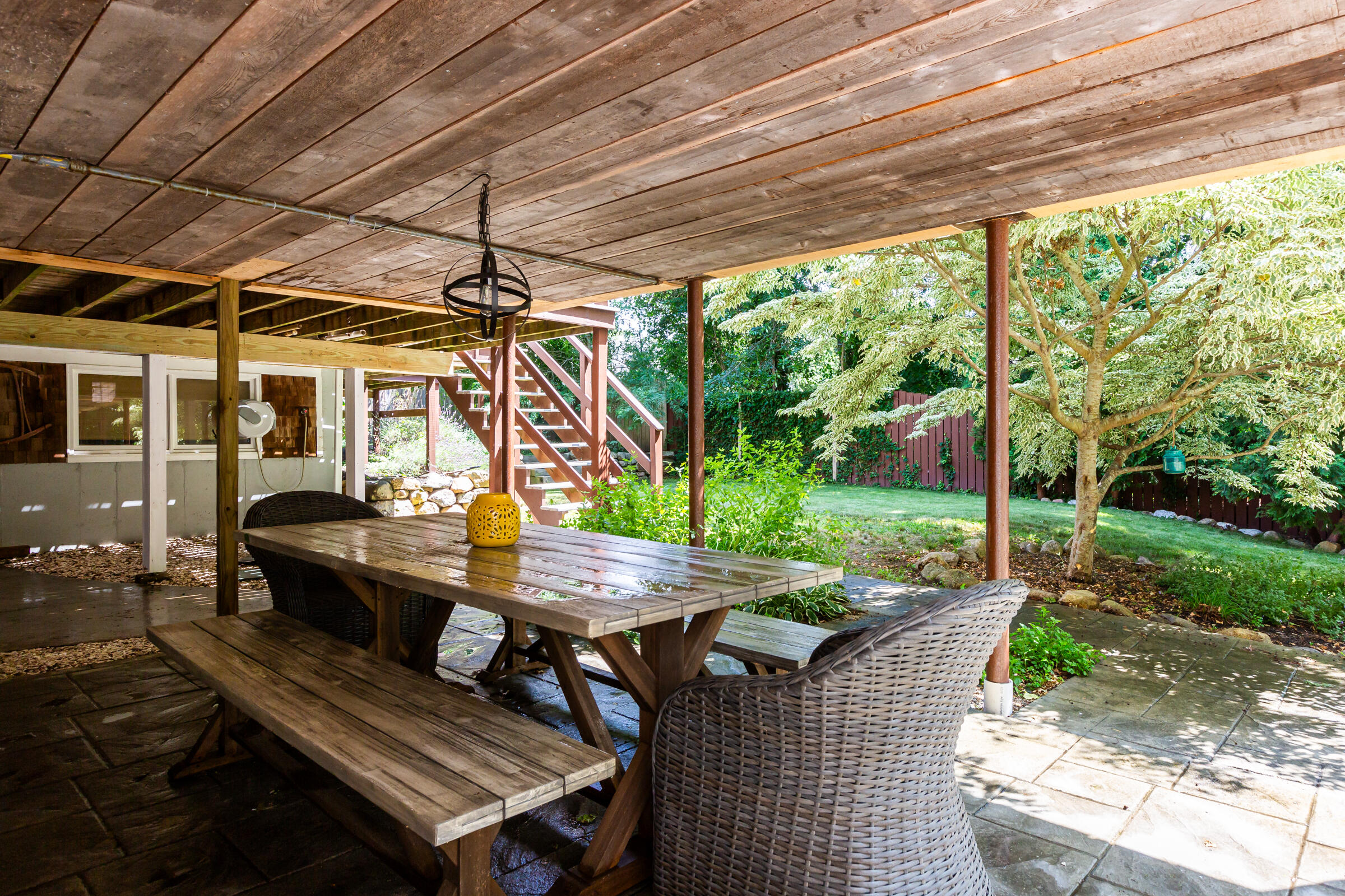 31 Soundview Road Centerville, MA 02632 - Photo 36 of 50 a view of a patio with table and chairs potted plants with wooden floor and fence