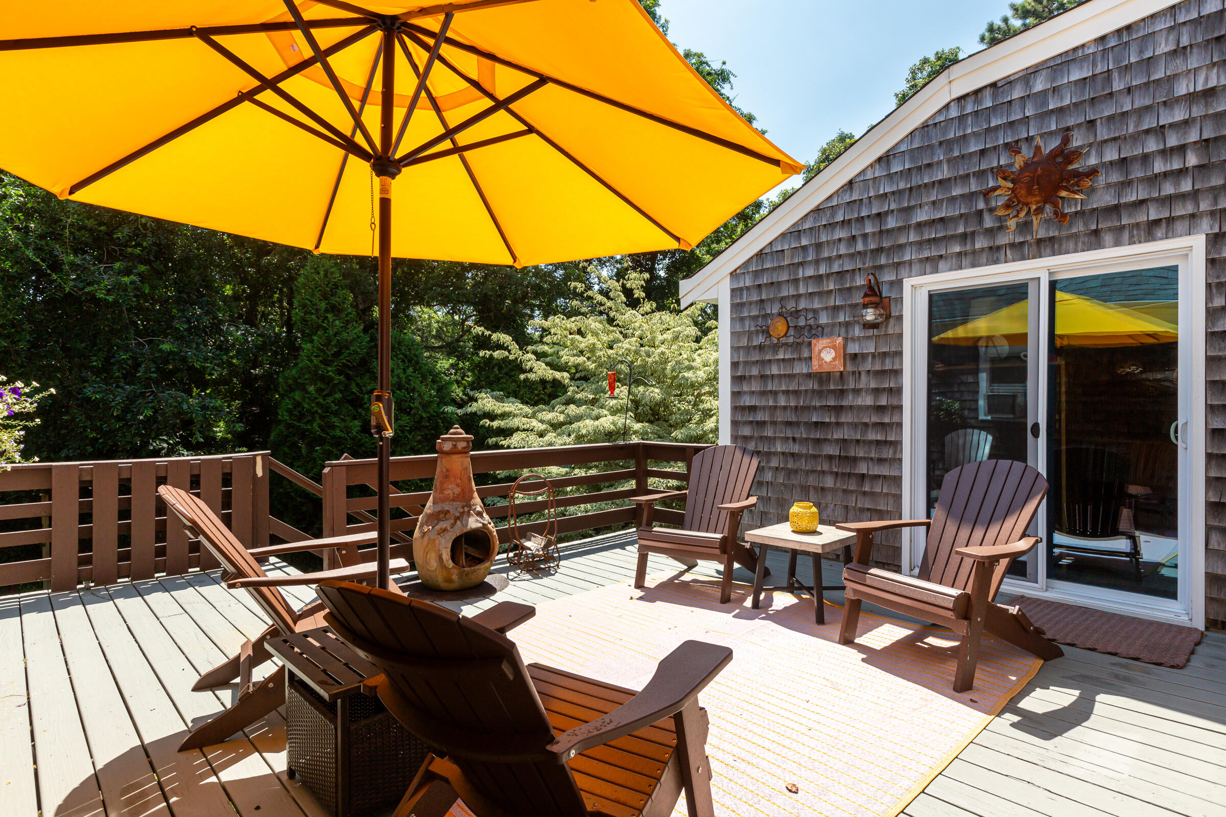 31 Soundview Road Centerville, MA 02632 - Photo 42 of 50 a view of a patio with a table and chairs under an umbrella