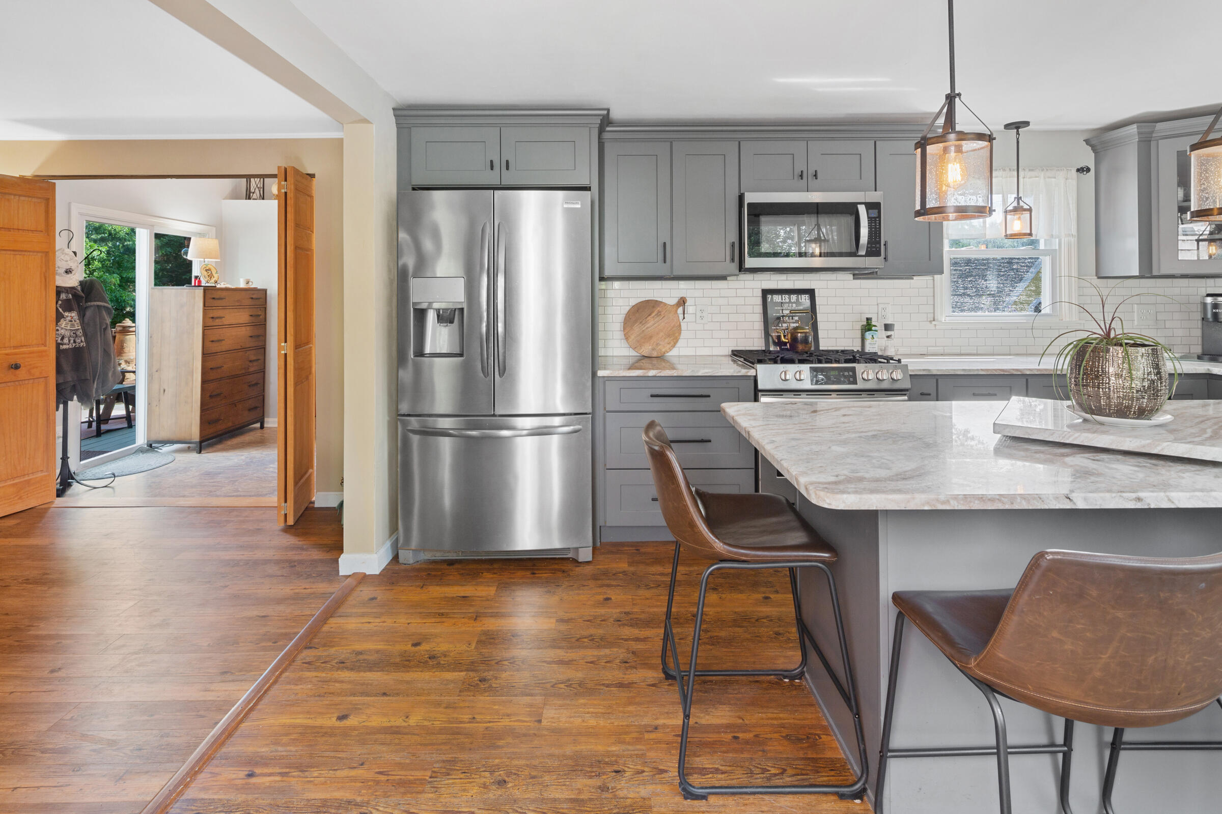 31 Soundview Road Centerville, MA 02632 - Photo 5 of 50 a kitchen with granite countertop a refrigerator a stove a sink dishwasher and white cabinets with wooden floor